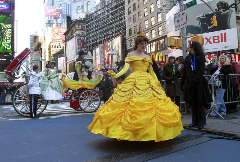 GRAND OPENING: Disney characters Princess Tiana, from "The Princess and the Frog," in carriage, and Belle, from "Beauty and the Beast," are featured in a sidewalk parade at the grand opening celebration of the Times Square Disney Store in New York on Tuesday. The new store is the crown jewel among the approximately 360 the company operates worldwide.