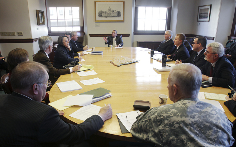 Gov. Paul LePage, background center, holds his first Cabinet meeting Monday at the State House in Augusta. The Republican governor met with departing commissioners from the Baldacci administration, thanking them for assisting with the transition and making sure that state agencies continue to have leadership while he selects his own staff and works through the confirmation process. The governor asked current department heads to hold off on rule-making and to consult with him before acting on urgent matters. He also said his office wants to be kept informed about media releases.