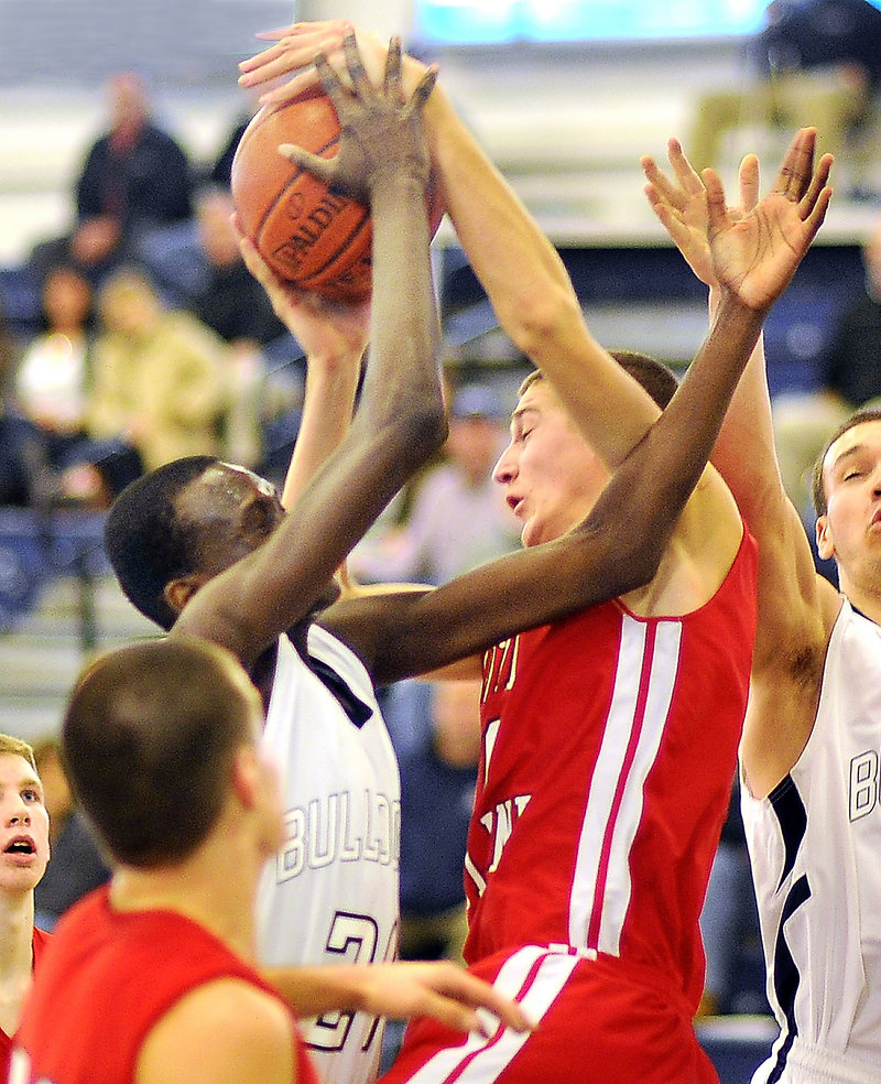 Pete Donato, left, who scored 19 points for Portland, contends with Matt Russell of South Portland for a first-half rebound at the Expo.