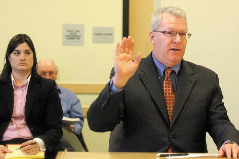 Former Maine Turnpike Authority Director Paul Violette is sworn in before the Legislature’s Government Oversight Committee on Friday. Violette repeatedly declined to answer questions from the committee regarding gift card purchases.