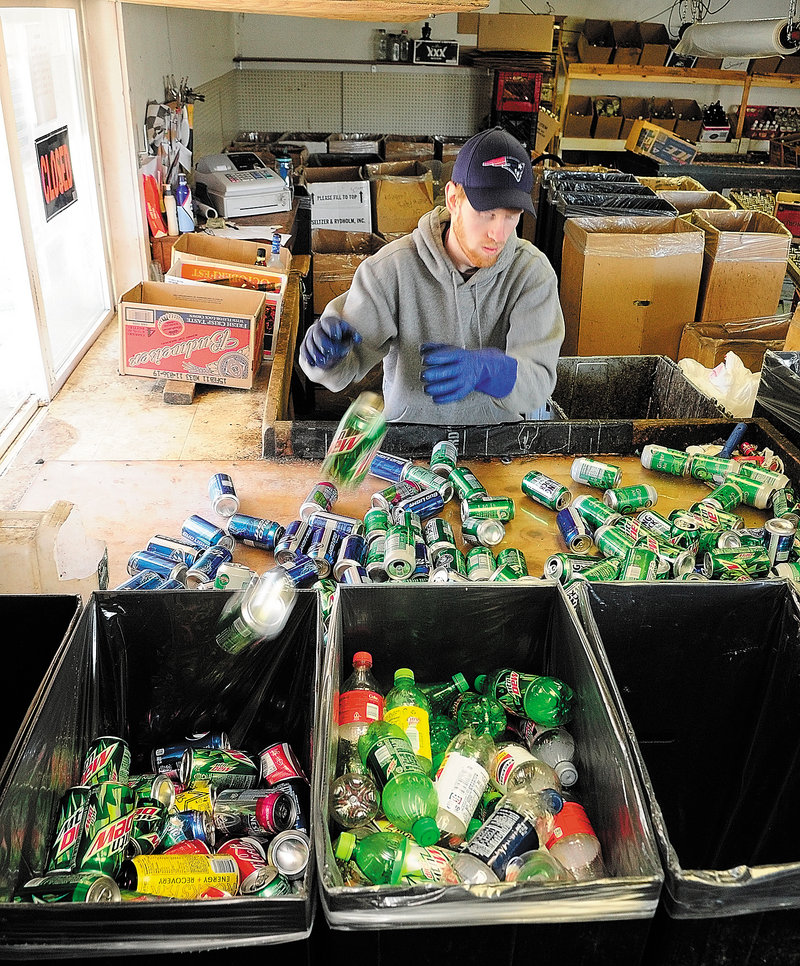 Sean Putman-Labbe sorts returnables Friday at Bottoms Up in Augusta. "Right now, we're considering expanding and hiring more employees," he said. If the law is hobbled, that wouldn't be an option.