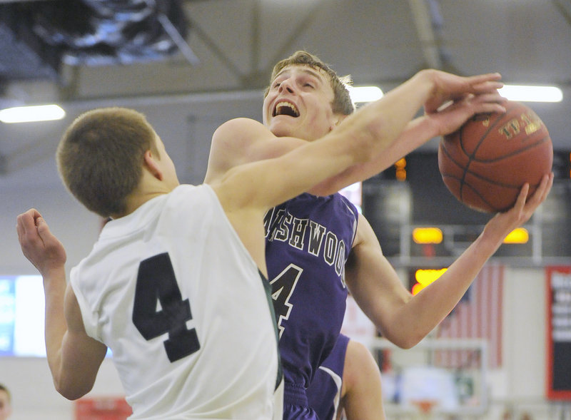 Daniel Veino of Marshwood is stopped by Bonny Eagle's Dustin Cole during a Western Class A quarterfinal game on Saturday at the Portland Expo. Bonny Eagle won the game, 61-40.