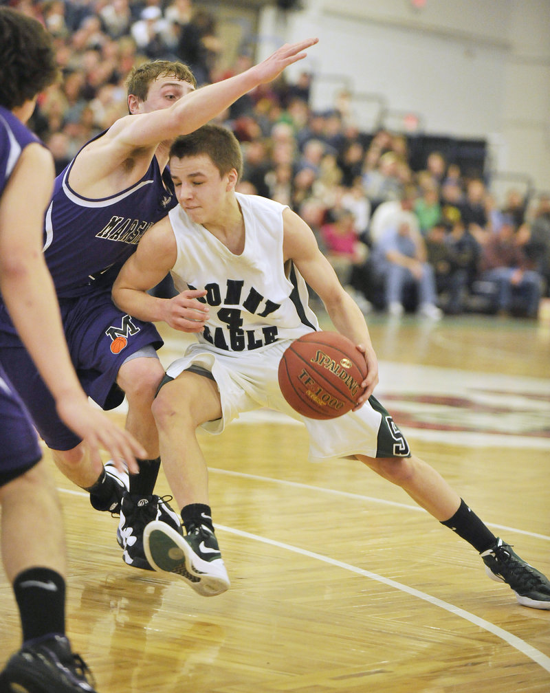 Bonny Eagle's Dustin Cole tries to drive to the basket but is cut off by Marshwood's Daniel Veino.
