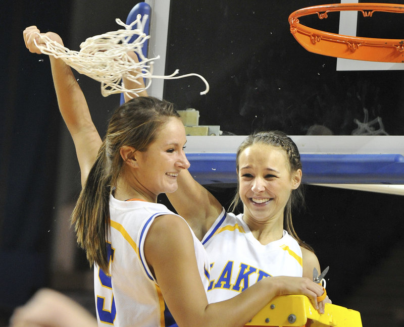 Yes, it’s a celebration. Abby Craffey, left, and Rachel Wandishin twirl the nets they just cut down after Lake Region captured the Western Class B girls’ basketball title with a win over Greely.