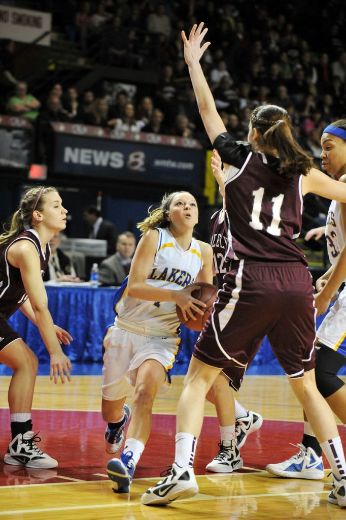 Sydney Hancock of Lake Region drives against Greely defender Ashley Storey, right. Hancock was named the tournament’s outstanding player after scoring 22 points in the final.