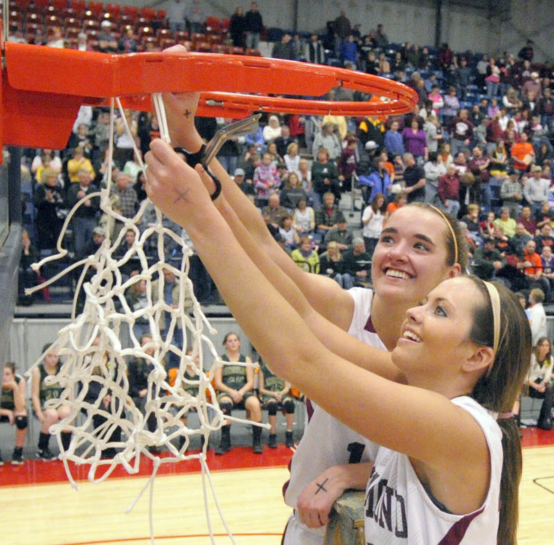 Richmond captains Jamie Plummer, top, and Danica Hurley cut down the net after the Bobcats won the Western Class D championship at the Augusta Civic Center.