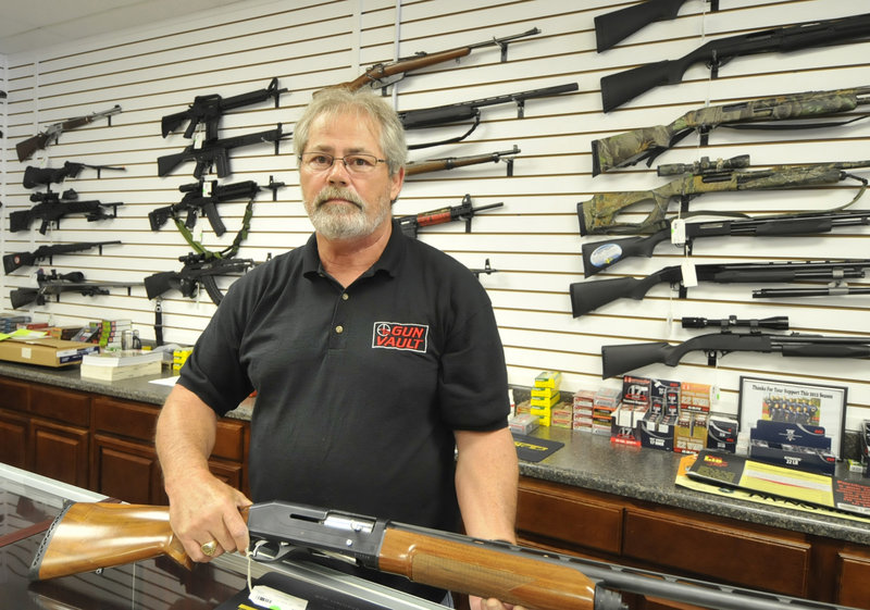 Randy Hodges holds a firearm Monday at the Gun Vault in High Point, N.C. Besides a rise in gun sales, the Colorado shootings have triggered a fierce debate over gun control.