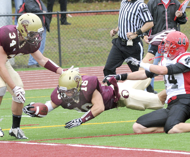 Andrew Libby, who rushed for 185 yards and scored three touchdowns Saturday, dives past Brendon Smith of Scarborough to score during Thornton Academy’s 35-7 win.