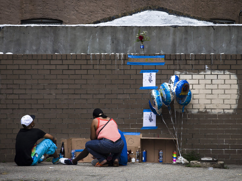 Mourners visit a memorial for Antiq Hennis in the Brownsville neighborhood of Brooklyn on Monday.