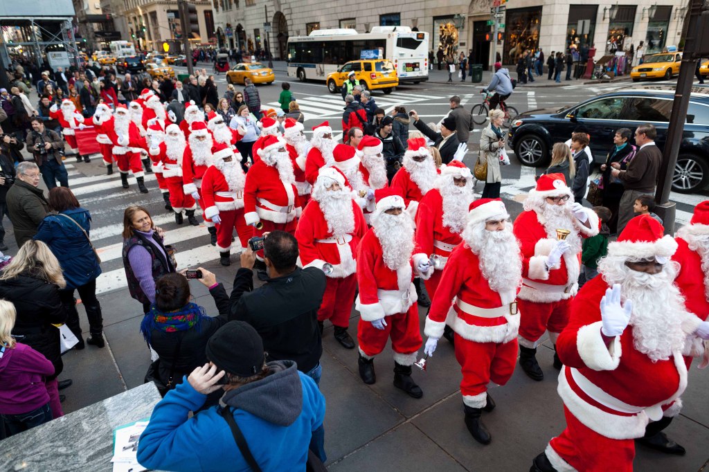 Charity workers dressed as Santa Claus walk up Fifth Avenue in New York in 2011 during the Volunteers of America annual Sidewalk Santa Parade to raise money for holiday food for needy residents. Volunteers of America-Greater New York says the parade and its Sidewalk Santa fundraising efforts have been retired, and the organization is using other more effective ways to raise money for its “Hope and Hearth” food voucher program. The parade traditionally took place the Friday after Thanksgiving to kick off the organization’s program that would have Santas trying to get donations from people passing by their sidewalk locations.