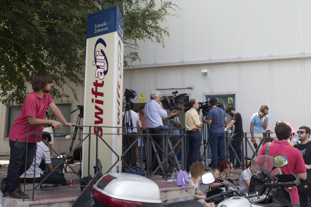 Journalists wait for news outside the Spanish Swiftair office in Madrid, Spain, Thursday. An Air Algerie flight carrying 116 people from Burkina Faso to Algeria’s capital disappeared from radar early Thursday over northern Mali.