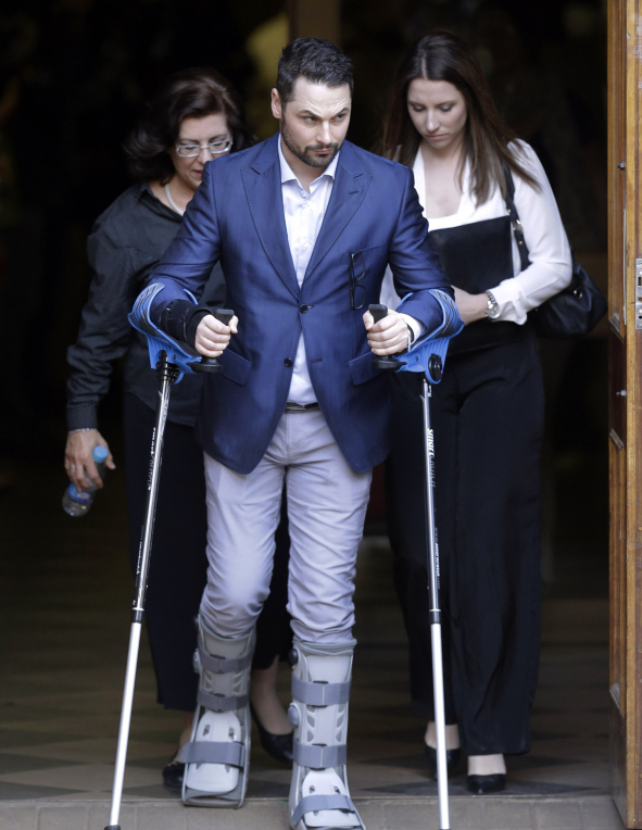 Oscar Pistorius assisted by sister Aimee Pistorius, right, leaves the high court in Pretoria, South Africa, Friday. Following the testimony hearing, Judge Thokozile Masipa is expected to announce Pistorius’ sentence on Tuesday after she found him guilty last month of culpable homicide for negligently killing Steenkamp, but acquitted him of murder.