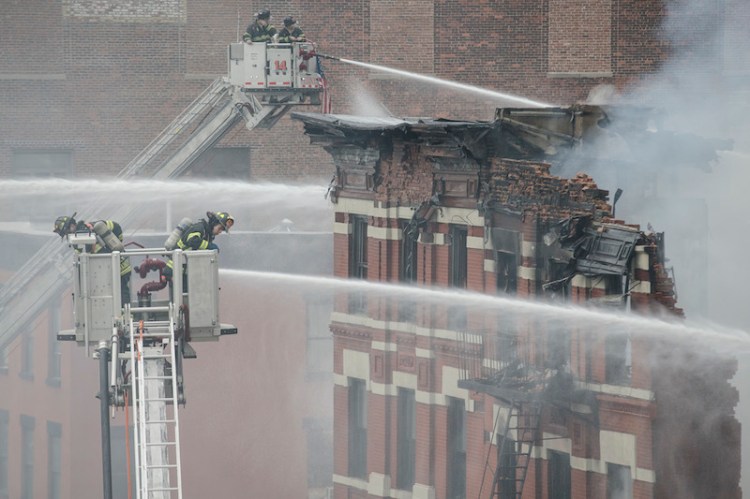 Firefighters spray water on a collapsed building in New York's East Village.