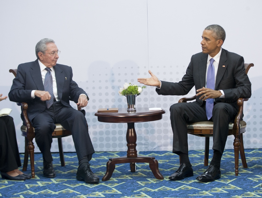 U.S. President Barack Obama, right, extends his hand to Cuban President Raul Castro, left, during their meeting at the Summit of the Americas, in Panama City, Panama, on Saturday.