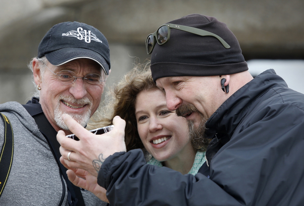 Jeffrey Simpson of Fryeburg, right, shares an image with Stephanie Cichowski of Freeport and Rod Pervier of Pownal.
