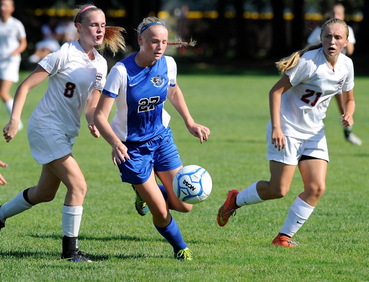 Sacopee Valley’s Jordan Miner takes the ball downfield between Freeport’s Johanna Bogue Marlow and Jordan Randall as Freeport hosts Sacopee Valley. The Hawks won 5-0 - their second straight shutout win to start the season. Gordon Chibroski/Staff Photographer