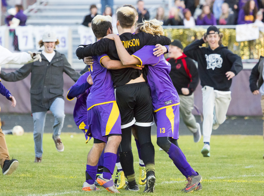 Cheverus goalkeeper Jake Tomkinson is swamped by teammates and fans Tuesday after the Stags beat Gorham 2-1 in the Class A South boys’ soccer quarterfinals. Tomkinson made 12 saves in the win.