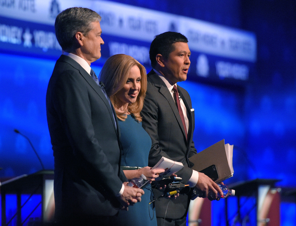 Debate moderators John Harwood, left, Becky Quick, center, and Carl Quintanilla take the stage for the CNBC Republican presidential debate Wednesday night.