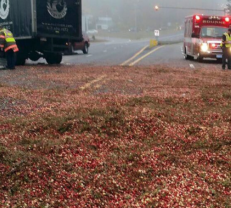 Police and rescue officials work at the scene of a head-on crash involving a truck carrying cranberries and another vehicle, which shut down the Sagamore Bridge. The Associated Press
