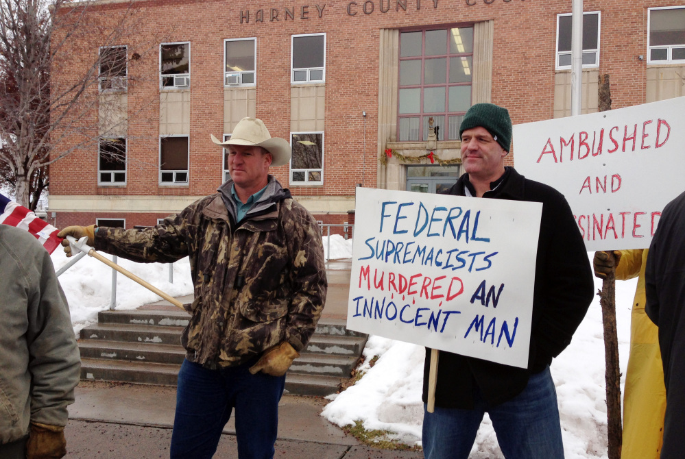 Protesters stand in front of the Harney County Courthouse in Burns, Ore., on Friday. “I’m angry” one activist said. “We’ve got a man that’s dead. Over what?”