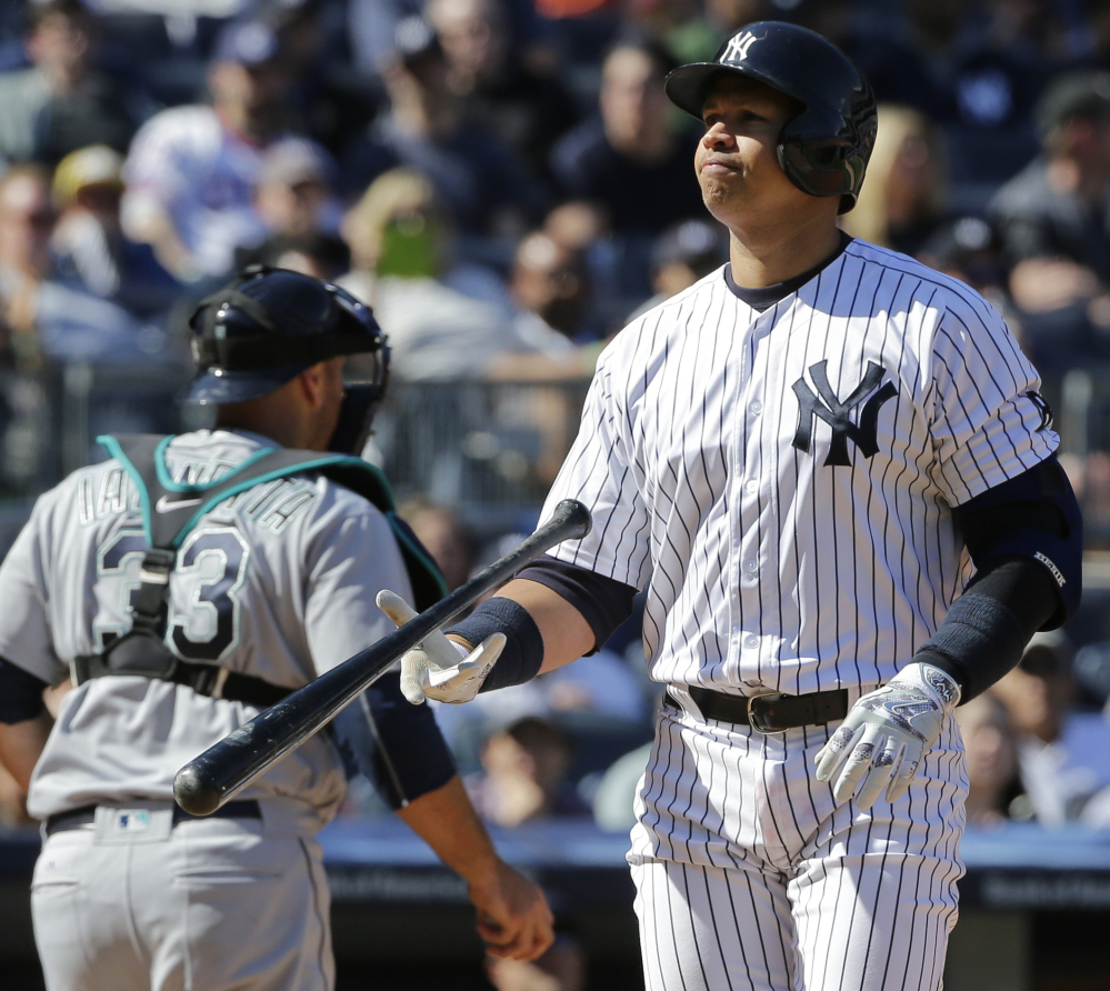 Alex Rodriguez of the Yankees flips his bat after striking out during the sixth inning against Seattle on Saturday. A-Rod fanned three times in a 3-2 loss.