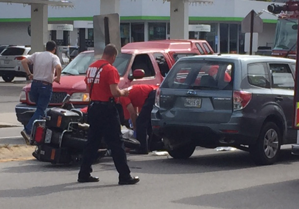 A motorcycle remains on its side in the street after a Tuesday morning crash on Brighton Avenue. Peggy Grodinsky/Food Editor