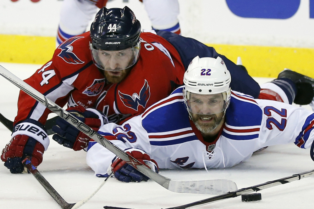 Washington Capitals defenseman Brooks Orpik, left, battles for a puck with the Rangers' Dan Boyle during last season's playoffs. Orpik missed much of the postseason and is looking forward just to being on the ice.