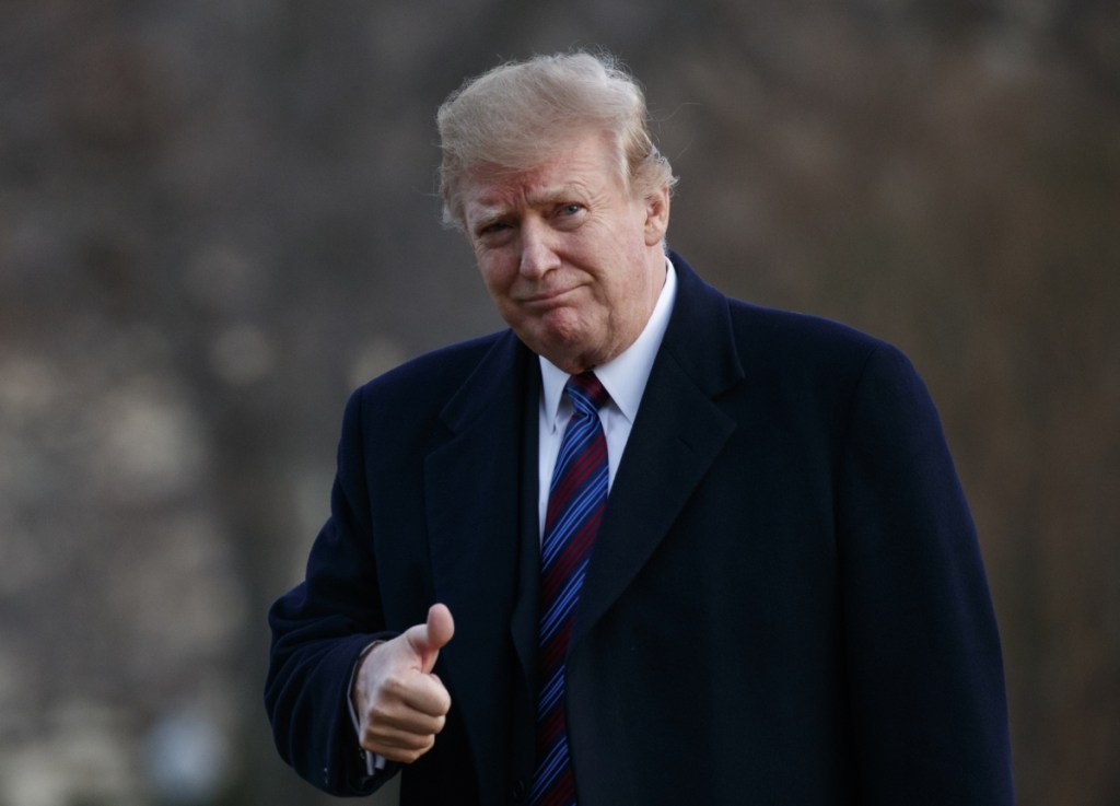 President Trump gives a thumbs-up after arriving on Marine One at the White House following a physical exam.