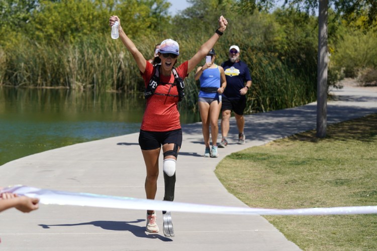 Jacky Hunt-Broersma finishes her 102nd marathon in 102 days, at Veterans Oasis Park, on Thursday in Chandler, Ariz.