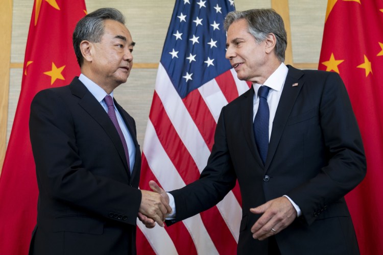 U.S. Secretary of State Antony Blinken, right, shakes hands with China's Foreign Minister Wang Yi during a meeting in Nusa Dua on the Indonesian resort island of Bali Saturday.