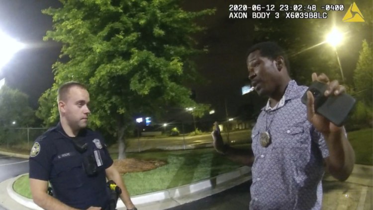 This screen grab taken from body camera video  shows Rayshard Brooks, right, as he speaks with Officer Garrett Rolfe, left, in the parking lot of a Wendy's restaurant in Atlanta on June 12, 2020. 