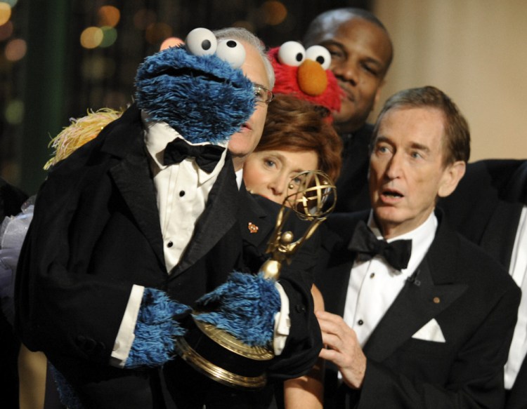 Bob McGrath, right, looks at the Cookie Monster as they accept the Lifetime Achievement Award for "Sesame Street" at the Daytime Emmy Awards on Aug. 30, 2009, in Los Angeles.Chris Pizzello/Associated Press file