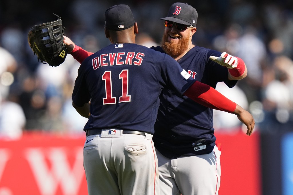 Justin Turner of the Boston Red Sox talks with manger Alex Cora