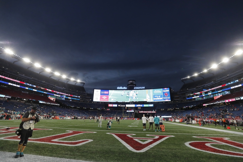 Tom Brady flag with another signature rubbed off, displayed on